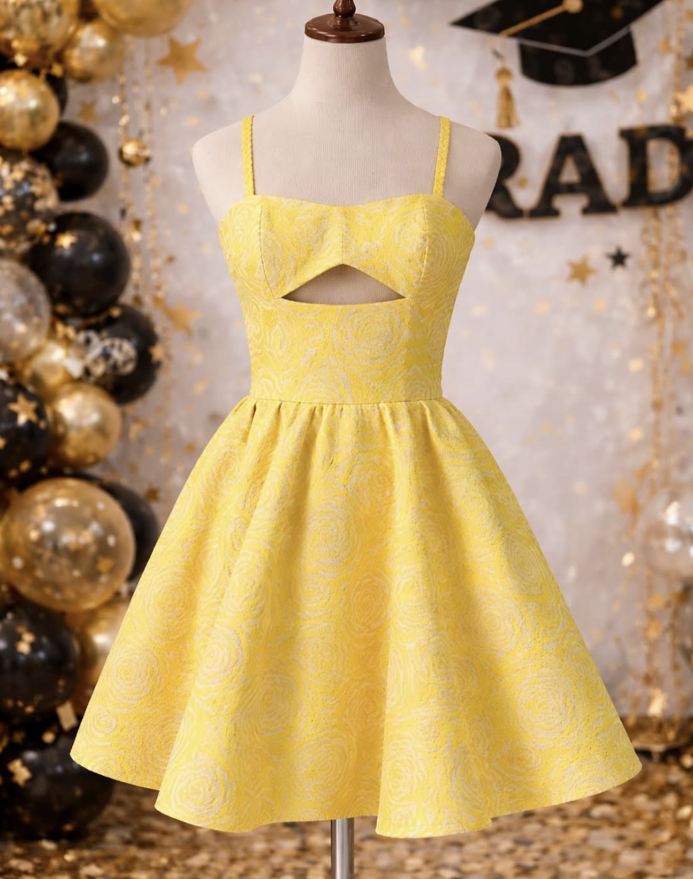 Yellow couture graduation dress on mannequin.