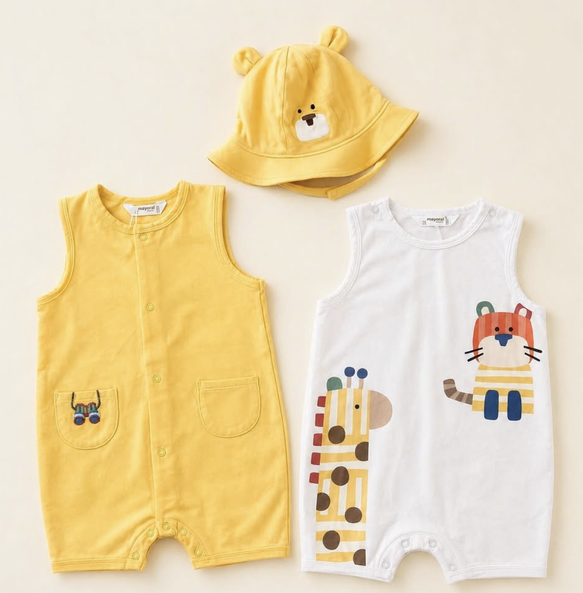 Yellow kids romper set with matching bucket hat.